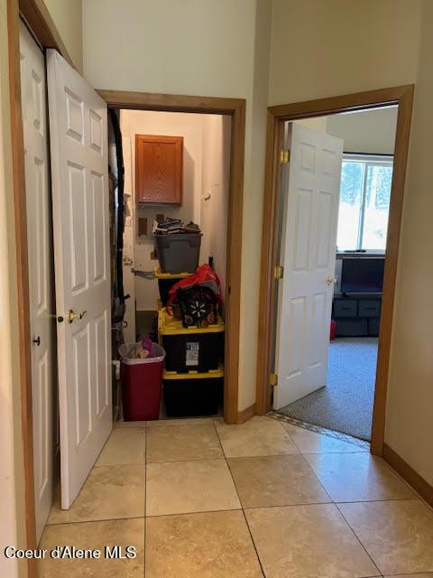 707 Patches Ln, Saint Maries, ID 83861 - corridor with light tile patterned floors and baseboards