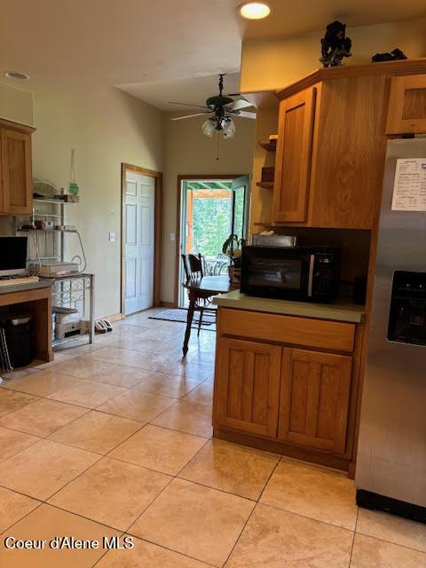 707 Patches Ln, Saint Maries, ID 83861 - kitchen featuring stainless steel fridge with ice dispenser, black microwave, ceiling fan, open shelves, and brown cabinetry