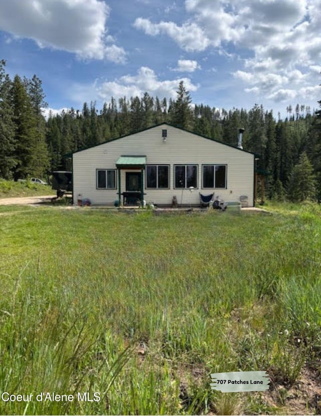707 Patches Ln, Saint Maries, ID 83861 - view of front of house with a view of trees and a front yard