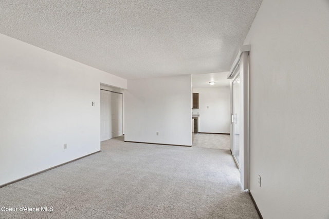 107 E Hattie Ave, Coeur Dalene, ID 83814 - empty room featuring light carpet and a textured ceiling