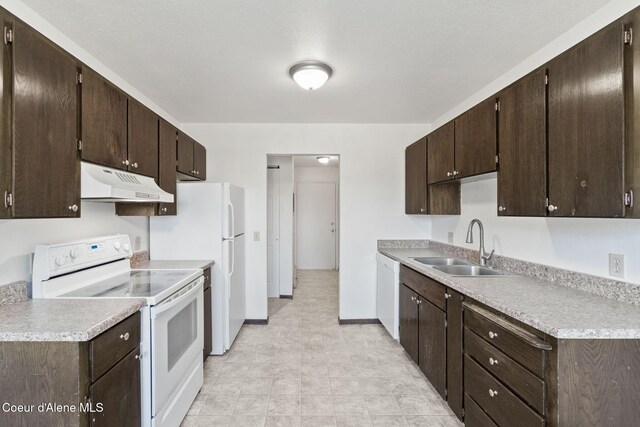 107 E Hattie Ave, Coeur Dalene, ID 83814 - kitchen featuring white appliances, under cabinet range hood, dark brown cabinetry, and light countertops