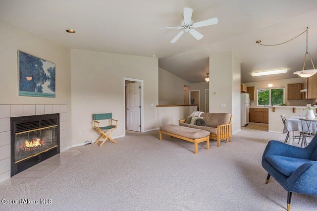 21013 N Circle Rd, Rathdrum, ID 83858 - living room with a tiled fireplace, light carpet, baseboards, a ceiling fan, and vaulted ceiling