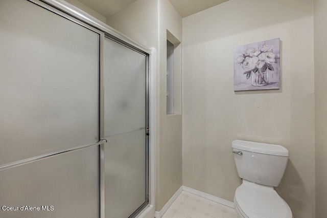 21013 N Circle Rd, Rathdrum, ID 83858 - bathroom with toilet, a stall shower, baseboards, and tile patterned floors