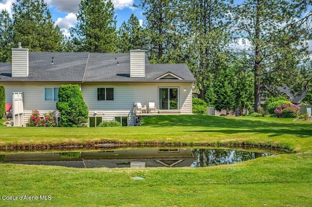 21013 N Circle Rd, Rathdrum, ID 83858 - back of house with a chimney and a lawn