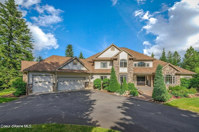 5336 E Shire Ln, Hayden, ID 83835 - traditional-style home with stone siding, asphalt driveway, and a garage