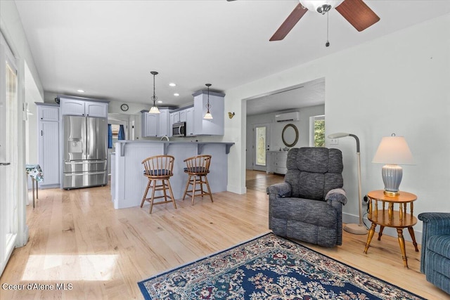 596 Overlake View Rd, Cocolalla, ID 83813 - living area featuring a wall mounted AC, light wood finished floors, a ceiling fan, and recessed lighting