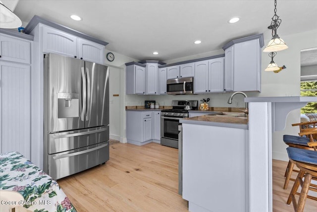596 Overlake View Rd, Cocolalla, ID 83813 - kitchen with stainless steel appliances, decorative light fixtures, light wood finished floors, and recessed lighting