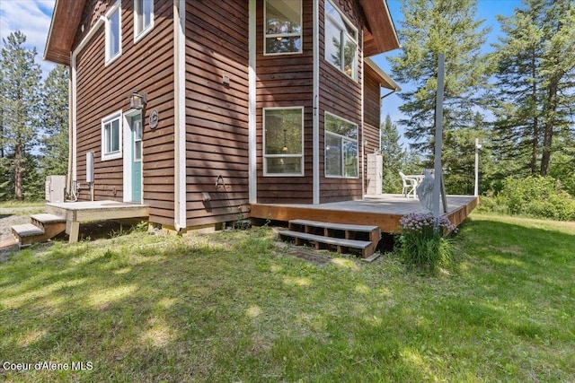596 Overlake View Rd, Cocolalla, ID 83813 - view of home's exterior with a wooden deck and a lawn