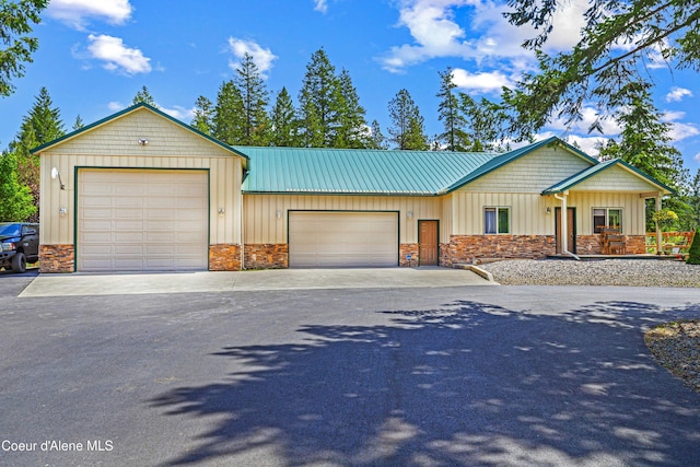 3857 E Beckon Ridge Rd, Coeur Dalene, ID 83814 - view of front of property with stone siding, board and batten siding, asphalt driveway, and a metal roof