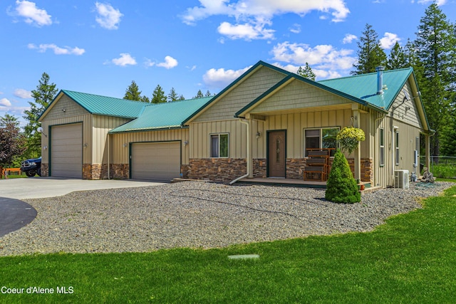 3857 E Beckon Ridge Rd, Coeur Dalene, ID 83814 - view of front of property with a garage, concrete driveway, board and batten siding, a front lawn, and a metal roof