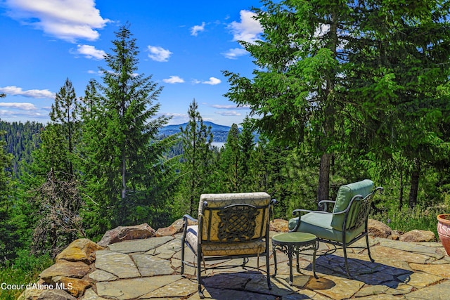 3857 E Beckon Ridge Rd, Coeur Dalene, ID 83814 - view of patio / terrace with a mountain view and a forest view