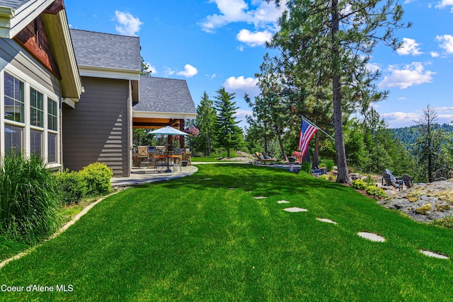 3857 E Beckon Ridge Rd, Coeur Dalene, ID 83814 - view of green lawn featuring a patio