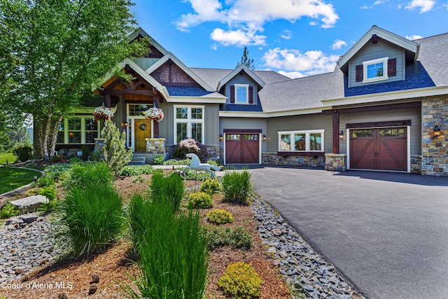 3857 E Beckon Ridge Rd, Coeur Dalene, ID 83814 - craftsman inspired home featuring stone siding, asphalt driveway, an attached garage, and roof with shingles