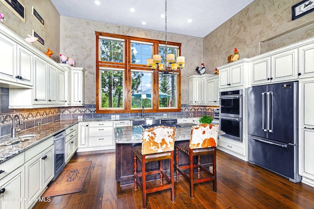 3857 E Beckon Ridge Rd, Coeur Dalene, ID 83814 - kitchen with high quality fridge, light stone counters, dark wood-style flooring, double oven, and recessed lighting