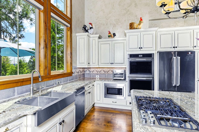 3857 E Beckon Ridge Rd, Coeur Dalene, ID 83814 - kitchen featuring stainless steel appliances, plenty of natural light, white cabinets, and light stone counters