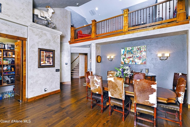 3857 E Beckon Ridge Rd, Coeur Dalene, ID 83814 - dining area featuring a towering ceiling, stairs, wood-type flooring, and a textured wall
