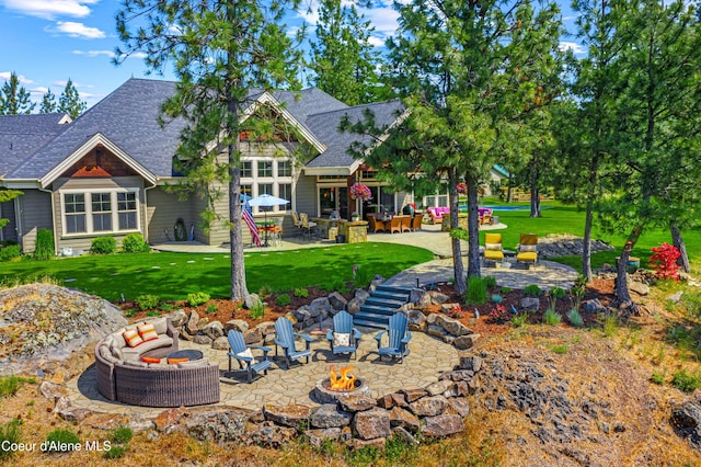 3857 E Beckon Ridge Rd, Coeur Dalene, ID 83814 - back of house featuring an outdoor fire pit, a patio, a shingled roof, and a lawn