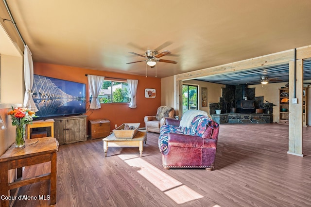 312 E 5th Ave, Clark Fork, ID 83811 - living area featuring a ceiling fan, wood finished floors, and a wood stove