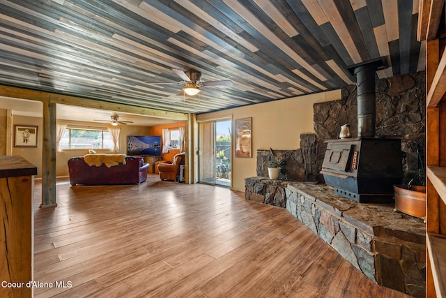 312 E 5th Ave, Clark Fork, ID 83811 - living room featuring a ceiling fan, wood finished floors, and a wood stove