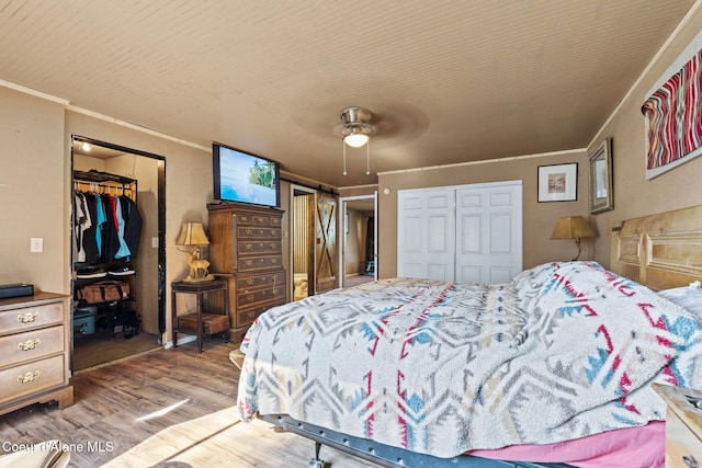 312 E 5th Ave, Clark Fork, ID 83811 - bedroom featuring ornamental molding, wood finished floors, a closet, a ceiling fan, and a spacious closet