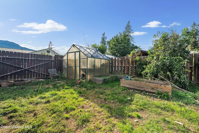 312 E 5th Ave, Clark Fork, ID 83811 - fenced backyard with an exterior structure, a garden, and an outdoor structure
