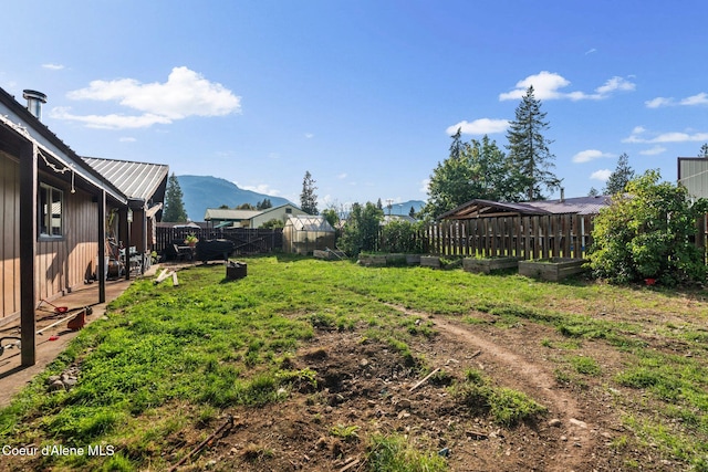 312 E 5th Ave, Clark Fork, ID 83811 - fenced backyard with a vegetable garden and a mountain view