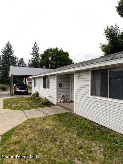 1920 E Front Ave, Coeur Dalene, ID 83814 - view of front facade with a front yard and a carport