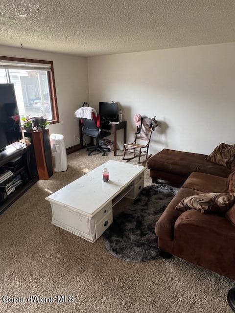 1920 E Front Ave, Coeur Dalene, ID 83814 - carpeted living area with a textured ceiling and a desk