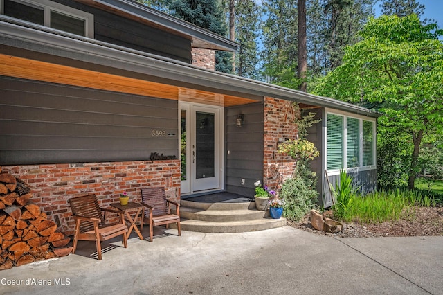 3593 W Fairway Dr, Coeur Dalene, ID 83815 - property entrance featuring brick siding and a patio