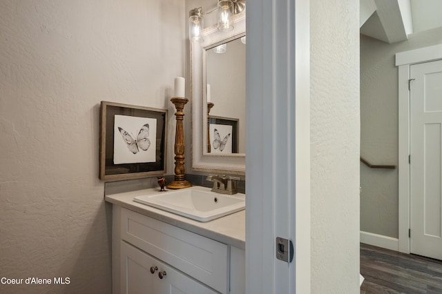 3593 W Fairway Dr, Coeur Dalene, ID 83815 - bathroom featuring vanity, a textured wall, wood finished floors, and baseboards
