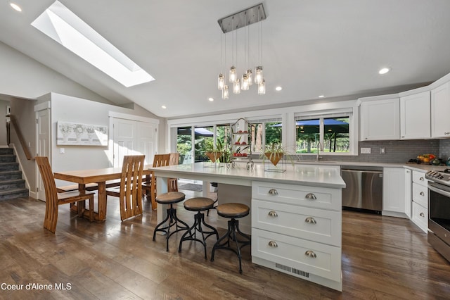 3593 W Fairway Dr, Coeur Dalene, ID 83815 - kitchen with stainless steel appliances, a skylight, plenty of natural light, a sink, and lofted ceiling