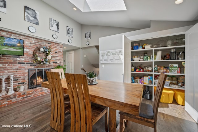 3593 W Fairway Dr, Coeur Dalene, ID 83815 - dining space with a skylight, wood finished floors, a fireplace, and high vaulted ceiling