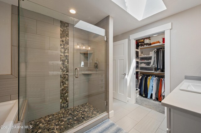 3593 W Fairway Dr, Coeur Dalene, ID 83815 - full bath with vanity, a stall shower, a walk in closet, recessed lighting, and a skylight