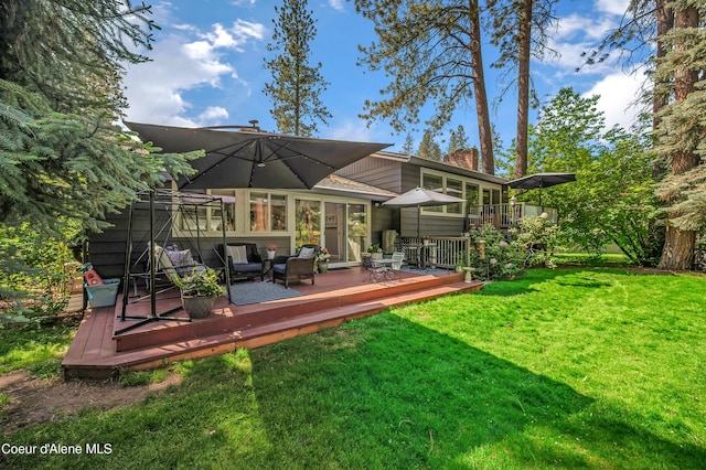 3593 W Fairway Dr, Coeur Dalene, ID 83815 - back of house featuring a chimney, a yard, and a wooden deck