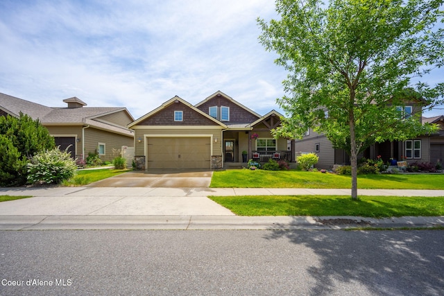 2636 W Renoir Dr, Coeur Dalene, ID 83815 - craftsman inspired home with a front lawn, stone siding, a porch, and concrete driveway