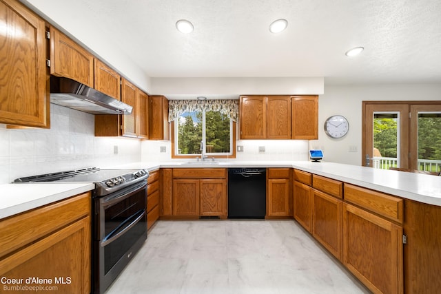 8416 N Haye Ln, Newman Lake, WA 99025 - kitchen with black dishwasher, double oven range, extractor fan, light countertops, and a peninsula