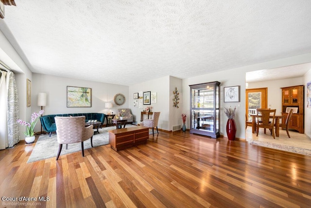 8416 N Haye Ln, Newman Lake, WA 99025 - living room with a textured ceiling and light wood-style floors