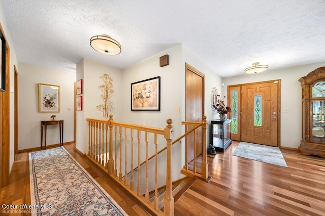 8416 N Haye Ln, Newman Lake, WA 99025 - entryway featuring wood finished floors, a textured ceiling, and baseboards