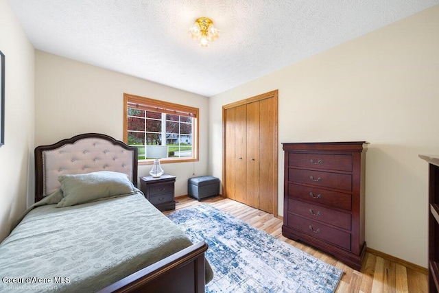 8416 N Haye Ln, Newman Lake, WA 99025 - bedroom with light wood finished floors, a closet, and baseboards