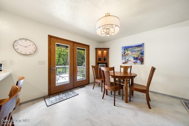 8416 N Haye Ln, Newman Lake, WA 99025 - dining area featuring french doors, a chandelier, baseboards, and a textured ceiling