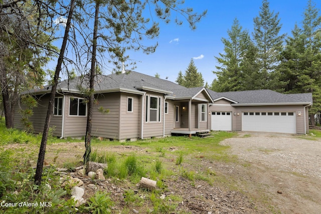 53 Koyokuk Trl, Spirit Lake, ID 83869 - ranch-style home featuring an attached garage, dirt driveway, and roof with shingles