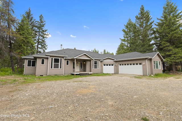 53 Koyokuk Trl, Spirit Lake, ID 83869 - view of front of property with a garage, driveway, and roof with shingles