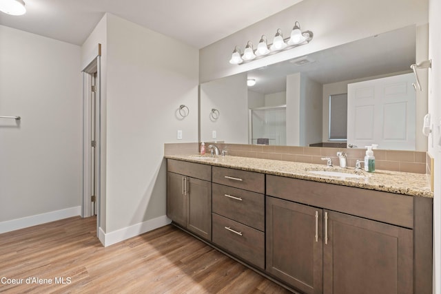 53 Koyokuk Trl, Spirit Lake, ID 83869 - full bath with double vanity, wood finished floors, and baseboards