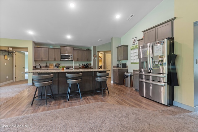 53 Koyokuk Trl, Spirit Lake, ID 83869 - kitchen with appliances with stainless steel finishes, baseboards, a breakfast bar, light stone countertops, and recessed lighting