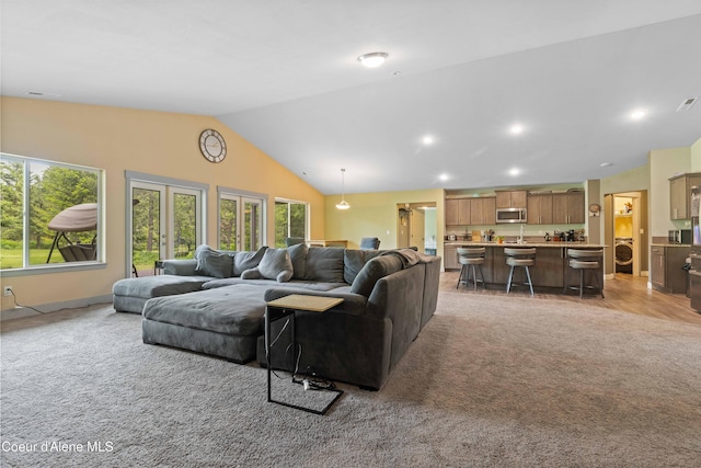53 Koyokuk Trl, Spirit Lake, ID 83869 - living room with lofted ceiling, light carpet, washer / dryer, and recessed lighting
