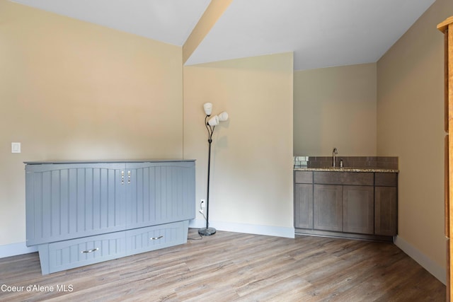 53 Koyokuk Trl, Spirit Lake, ID 83869 - unfurnished room featuring wood finished floors, baseboards, and a sink