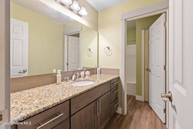 53 Koyokuk Trl, Spirit Lake, ID 83869 - bathroom with vanity, wood finished floors, tasteful backsplash, and baseboards