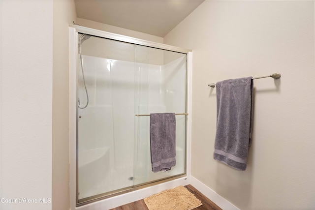 53 Koyokuk Trl, Spirit Lake, ID 83869 - full bathroom with a stall shower, wood finished floors, and baseboards