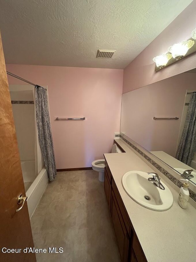 11019 W Crystal Bay Rd, Post Falls, ID 83854 - full bathroom with vanity, toilet, a textured ceiling, and shower / tub combo