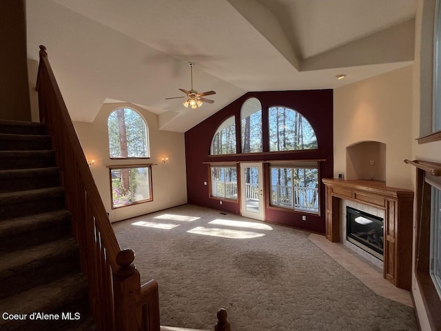 11019 W Crystal Bay Rd, Post Falls, ID 83854 - unfurnished living room featuring a fireplace, carpet, stairway, ceiling fan, and high vaulted ceiling